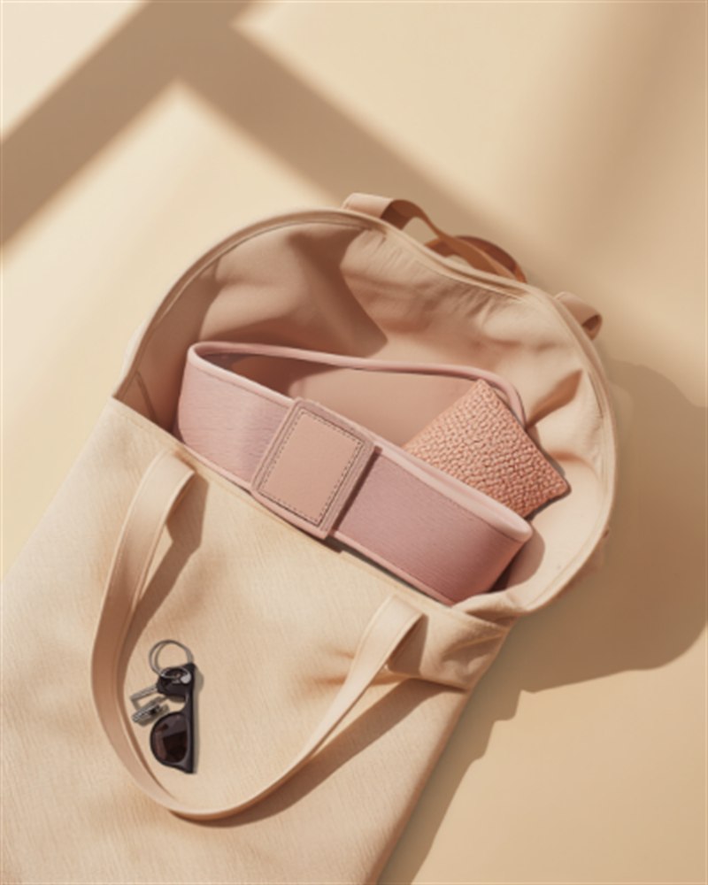 The Ember belt packed into a tote bag, ready to go anywhere